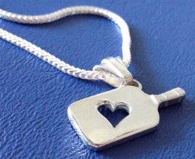 Pickleball jewelery with a pickleball paddle heart pendant.