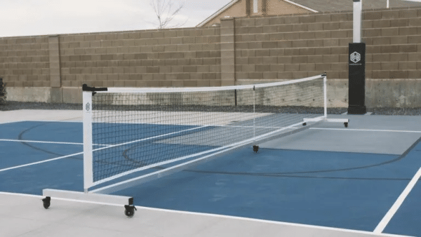 Image of a rolling portable pickleball net by Dominator.
